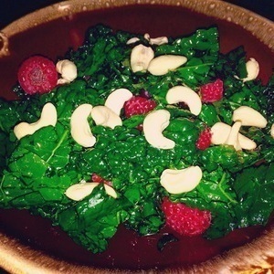 Massage kale salad with coconut water, raspberries, and cashew